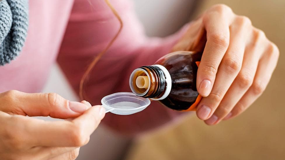 Cough syrup bottles arranged on a pharmacy shelf, representing India’s recent drug safety concerns and contamination reports.