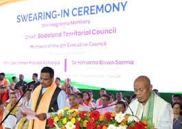 Swearing-in ceremony in Kokrajhar with Hagrama Mohilary taking oath before Assam Governor, surrounded by Bodos