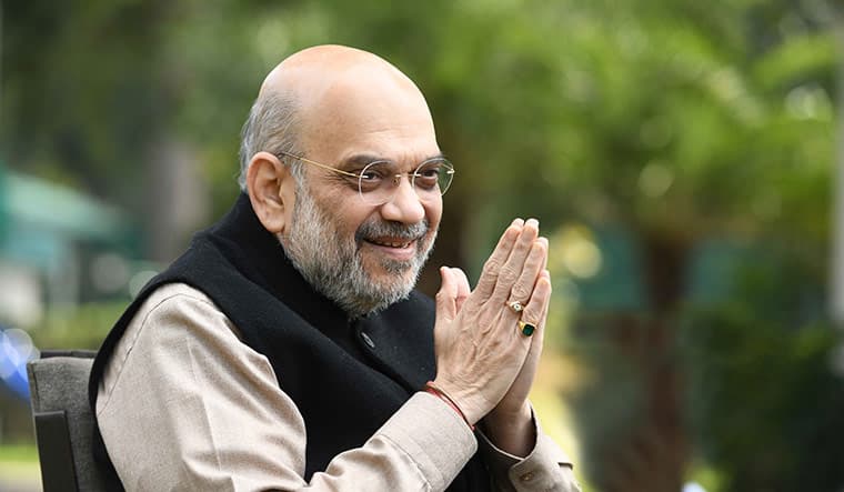 Union Home and Cooperation Minister greeting with folded hands during a public interaction in an outdoor setting.