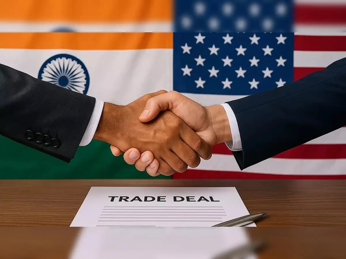 Indian and U.S. officials shake hands over a ‘Trade Deal’ document, symbolising growing economic and diplomatic partnership.